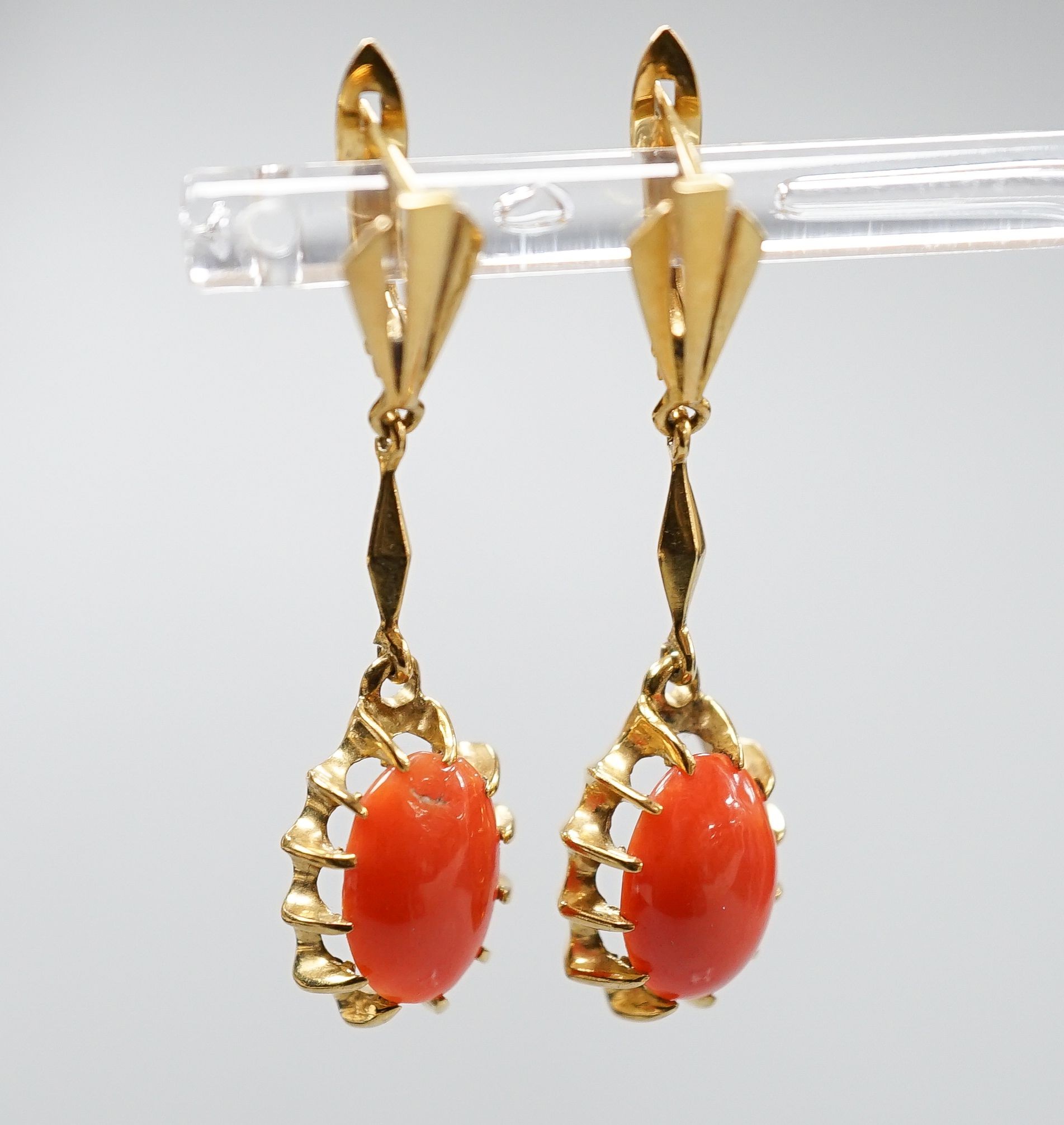 A pair of 18k and oval coral bead set drop earrings, 39mm, gross weight 6.8 grams.